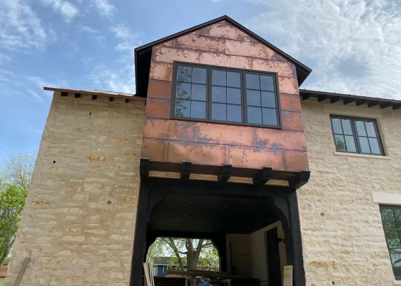 Copper metal panel facade on a stone building for Metal Roof Coating in Oregon